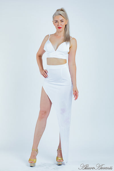 Woman wearing a white 2 pieces set, summer crop top and sexy side slit long skirt