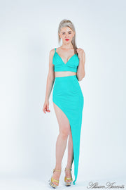 Woman wearing a turquoise 2 pieces set, summer crop top and sexy side slit long skirt