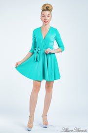 Women is wearing a turquoise mini swing dress, casual mid-sleeves all season appropriate dress