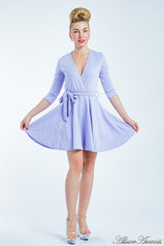 Women is wearing a lavender mini swing dress, casual mid-sleeves all season appropriate dress