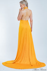 Woman showing an orange silk satin halter neck gown is backless.