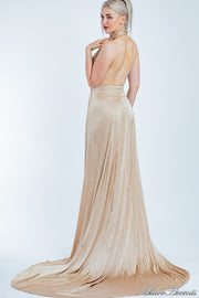 Woman showing a champagne gold silk satin halter neck gown is backless.