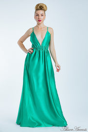 Woman wearing a jade green long satin dress that has a deep v neckline.
