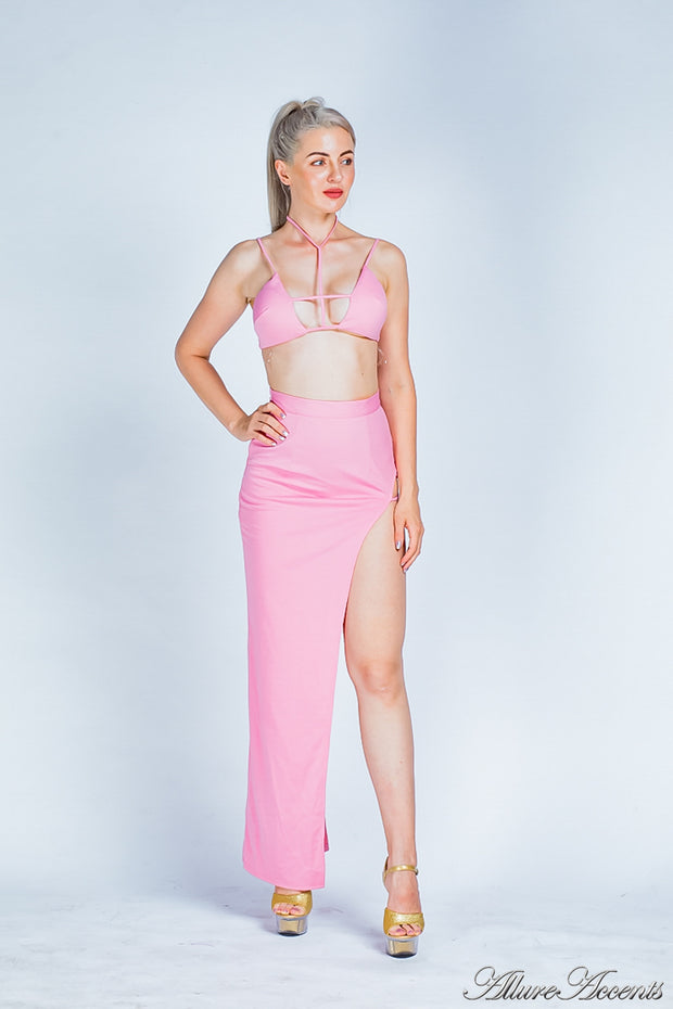 Woman is wearing a pink party 2 pieces outfit, sexy summer crop top and side slit long skirt