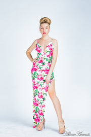 Woman wearing a pink summer floral party maxi, low cut back and has sexy side slit 