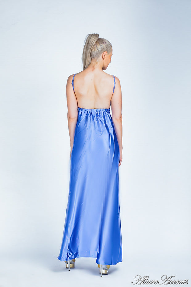Woman wearing a royal blue long satin dress showing it has a low back.