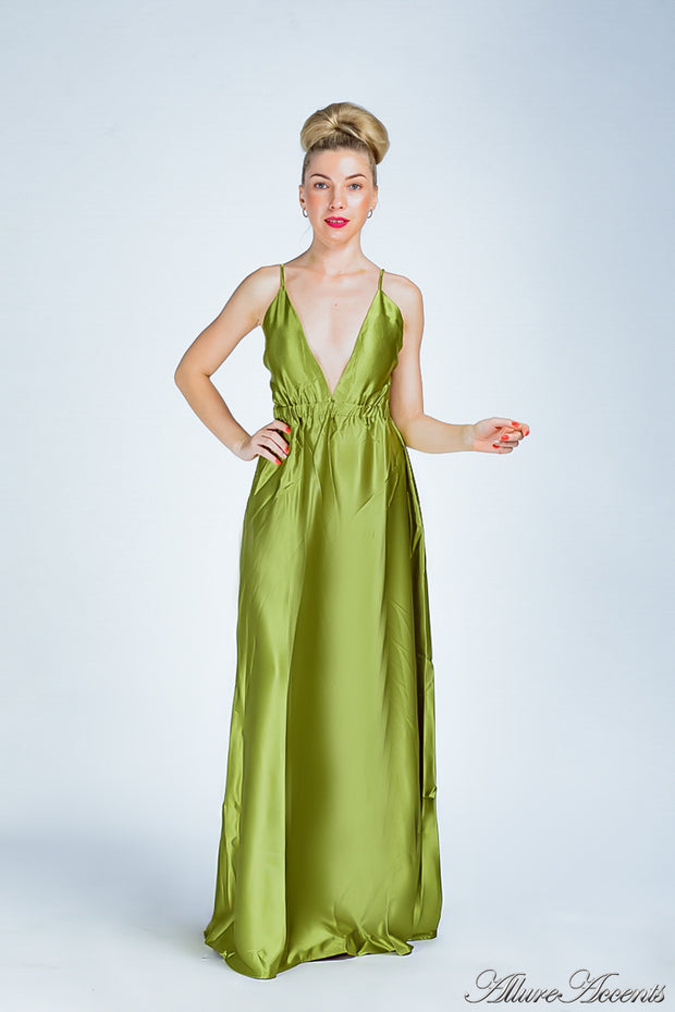 Woman wearing an olive green long satin dress that has a deep v neckline.