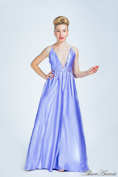 Woman wearing a periwinkle colored long satin dress that has a deep v neckline.