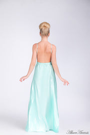 Woman wearing a tiffany blue colored long satin dress showing it has a low back.