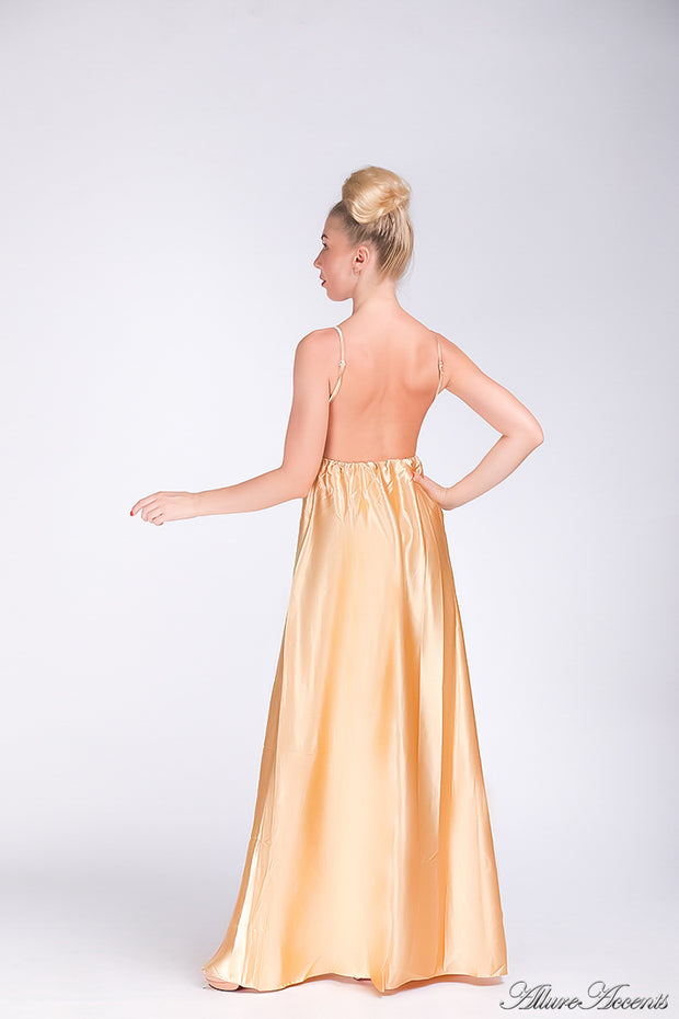 Woman wearing a champagne gold long satin dress that has a deep v neckline.