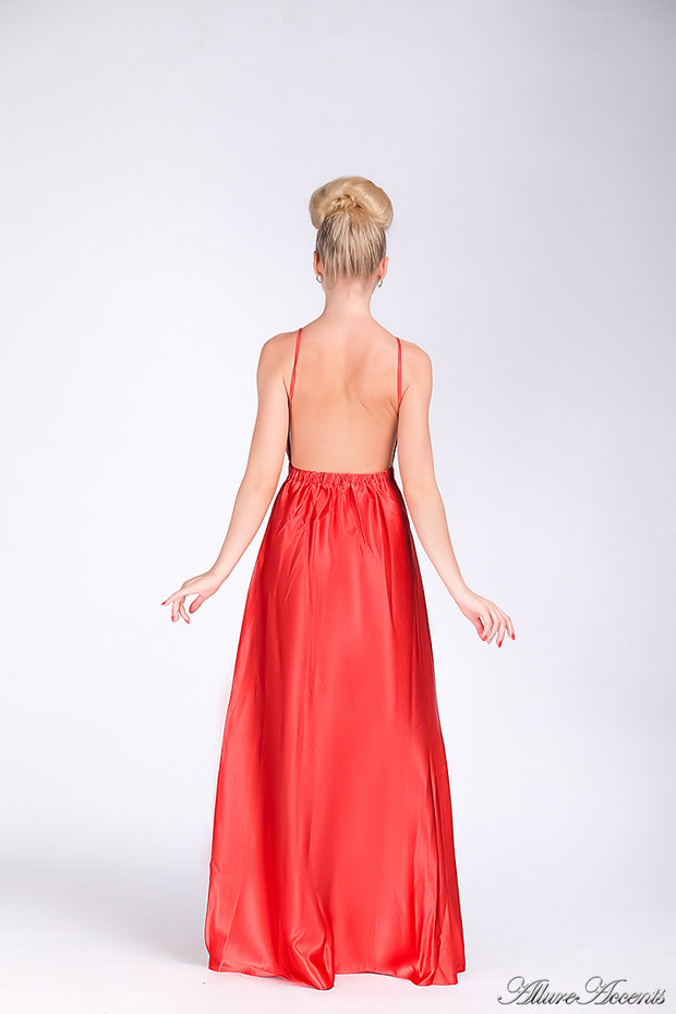 Woman wearing a red long satin dress showing it has a low back.