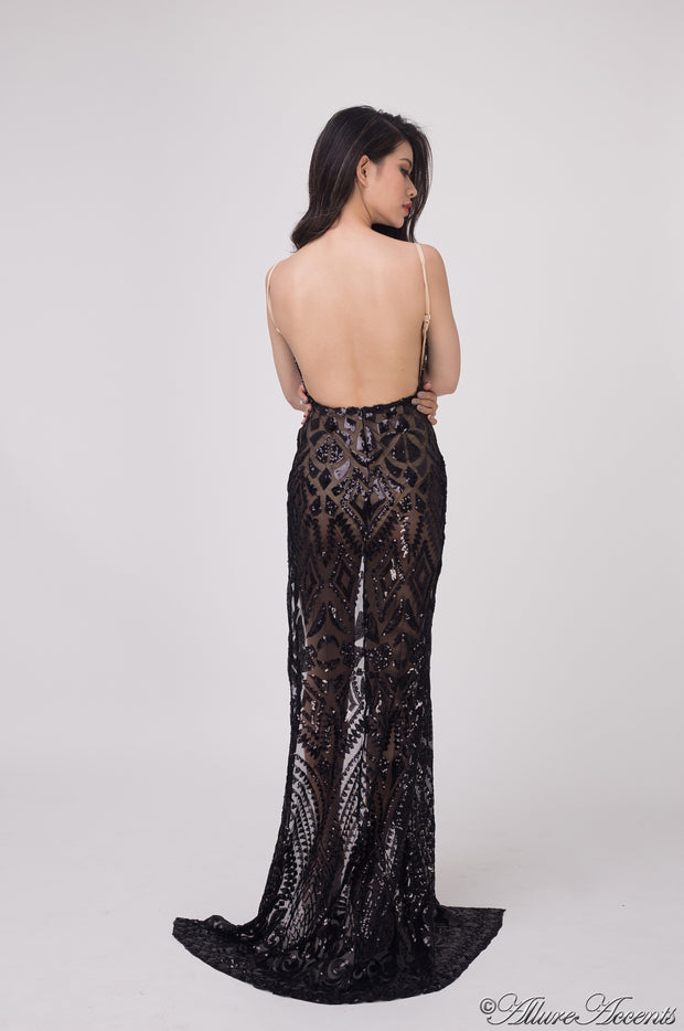 Woman showing the long black sequined dress is backless.