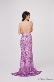 Woman showing the long purple sequined dress is backless.