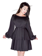 Woman is wearing a black mini layers dress, casual long sleeves dress appropriate for all seasons 