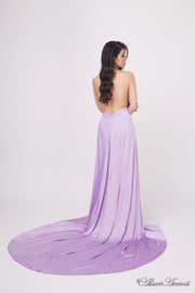 Woman showing a lavender silk satin halter neck gown is backless.