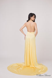 Woman showing a yellow silk satin halter neck gown is backless.