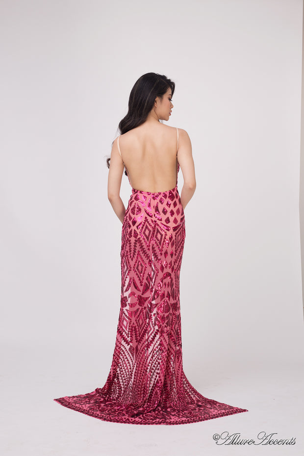 Woman showing the long red sequined dress is backless.