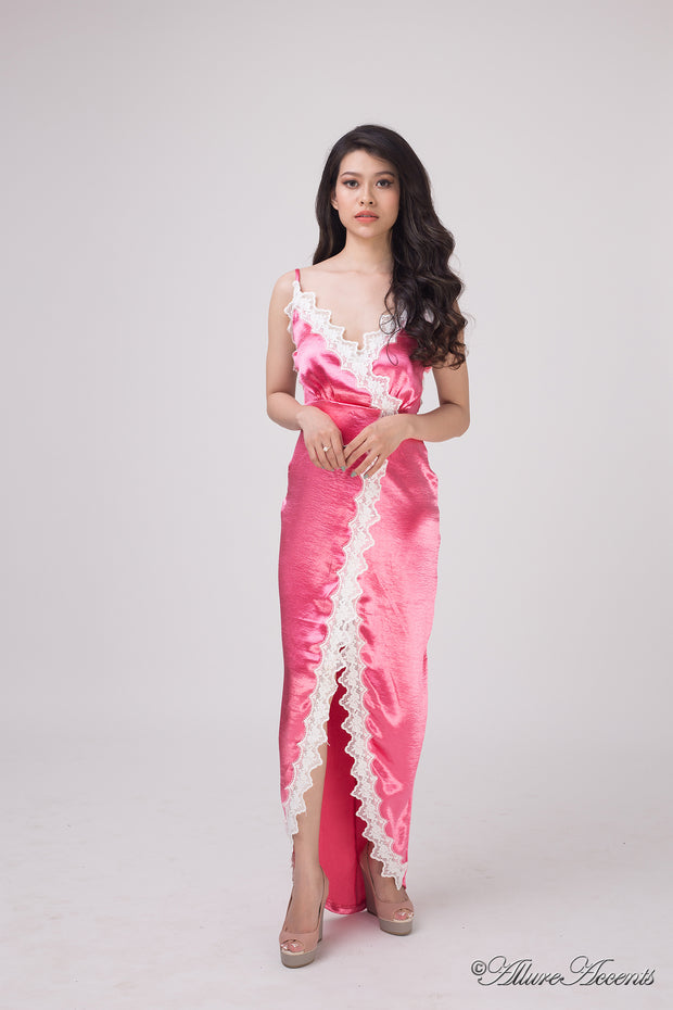 Woman wearing a hot pink satin midi dress, low-cut back with lace details