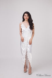 Woman wearing a white satin midi dress, low-cut back with lace details