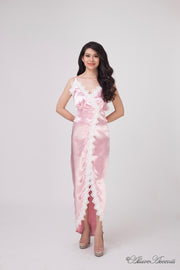 Woman wearing a light pink satin midi dress, low-cut back with lace details