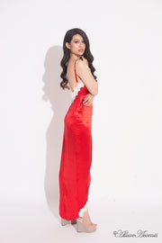 Woman wearing a red satin midi dress, low-cut back with lace details