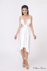 Woman wearing summer white satin party dress, hi-low style with chest paddings