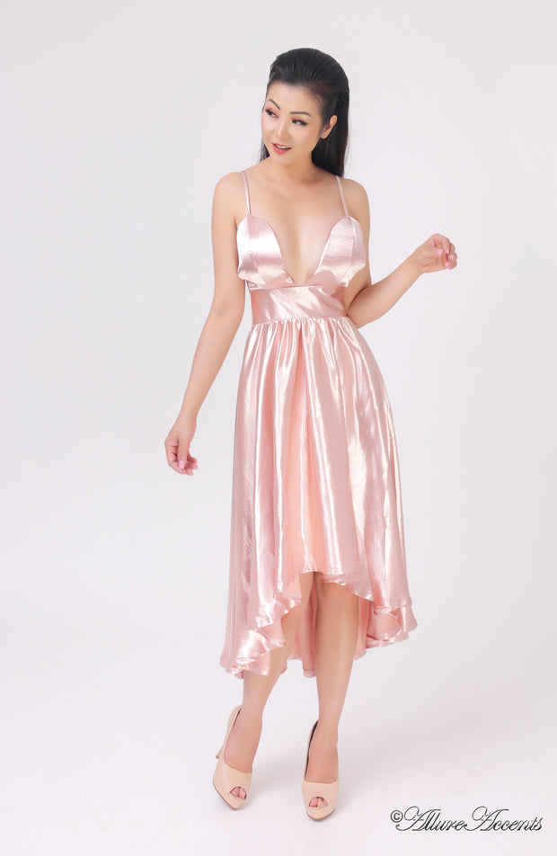 Woman wearing summer blush color satin party dress, hi-low style with chest paddings