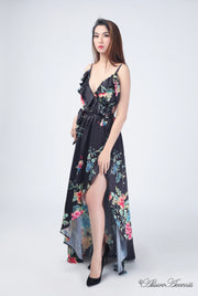 Women is wearing a black multi color floral maxi dress, sexy satin floral sundress with low-cut back with ruffles detail 