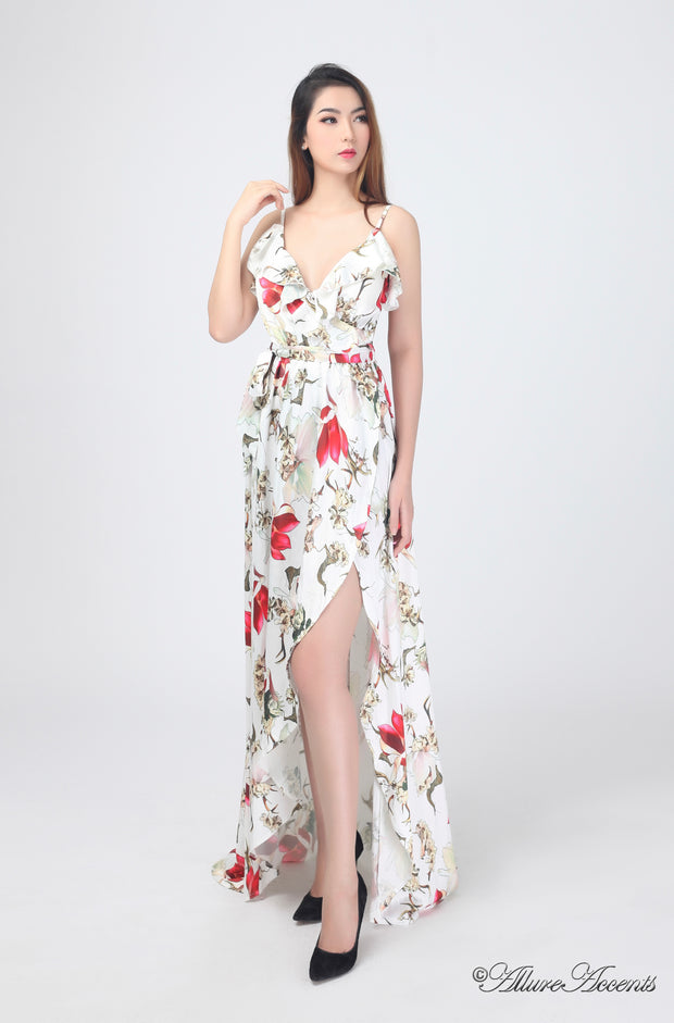 Women is wearing a white multi color floral maxi dress, sexy satin floral sundress with low-cut back with ruffles detail 