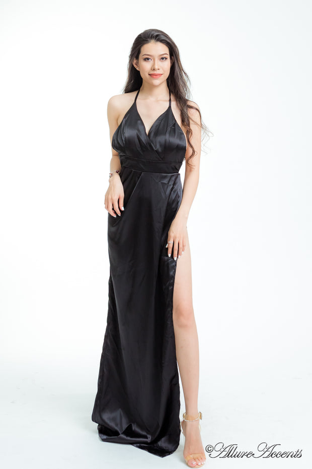 women wearing a long alter black satin maxi dress with high slit 