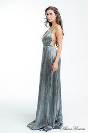 Woman wearing a silver colored maxi length slip dress with a deep v neck.