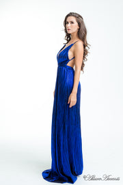 Woman wearing a royal blue colored maxi length slip dress with a deep v neck.