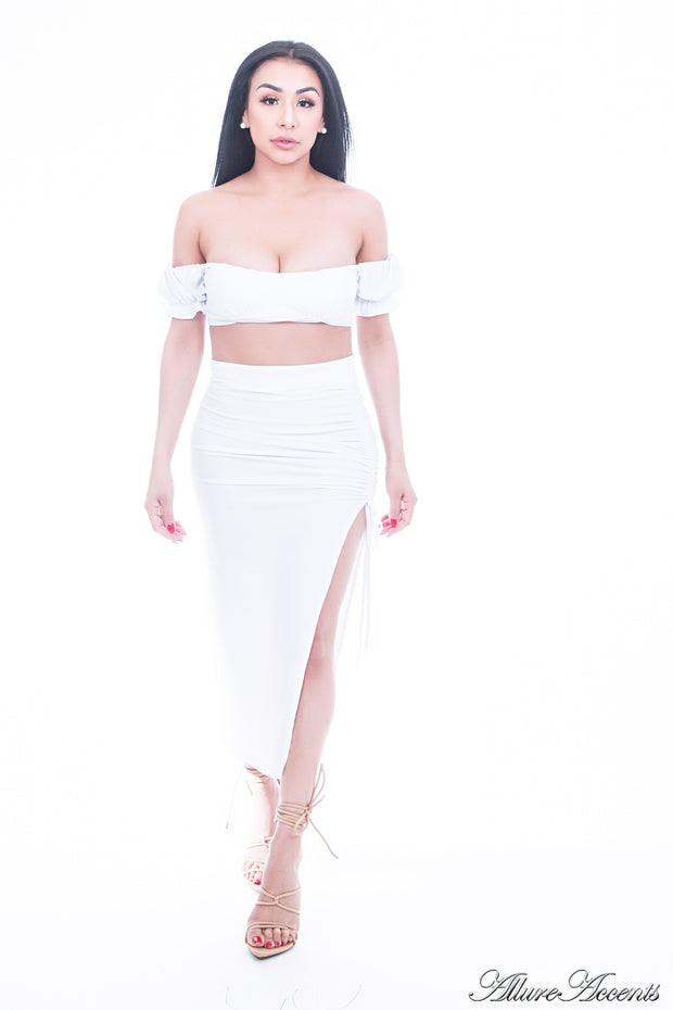 Woman is wearing a white 2 pieces summer party set, ruffle top and ruche tie skirt 