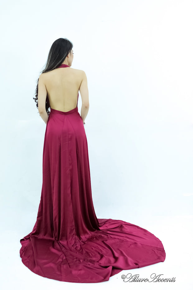 Woman showing a wine red silk satin halter neck gown is backless.