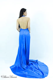 Woman showing a royal blue silk satin halter neck gown is backless.