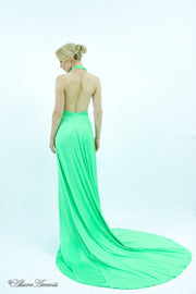 Woman showing a lime green silk satin halter neck gown is backless.