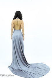 Woman showing a grey silk satin halter neck gown is backless.