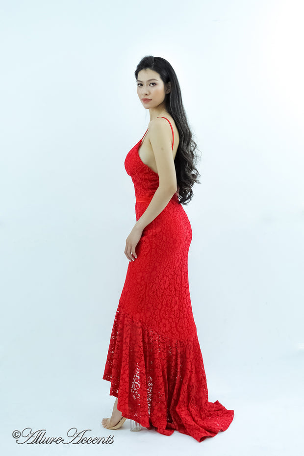 Woman wearing a red high-low floral lace dress.
