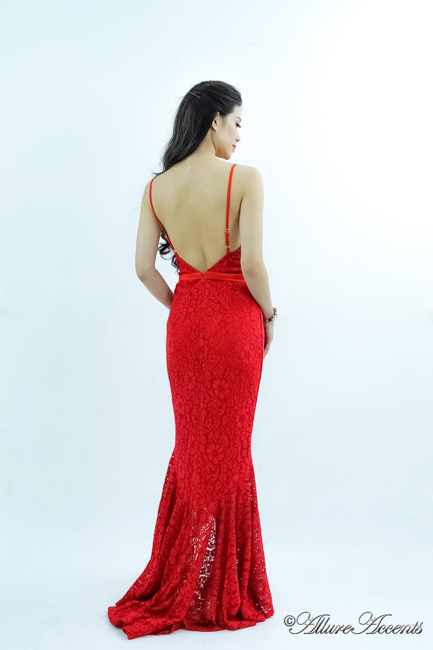 Woman showing a red high-low floral lace dress has a low back opening.
