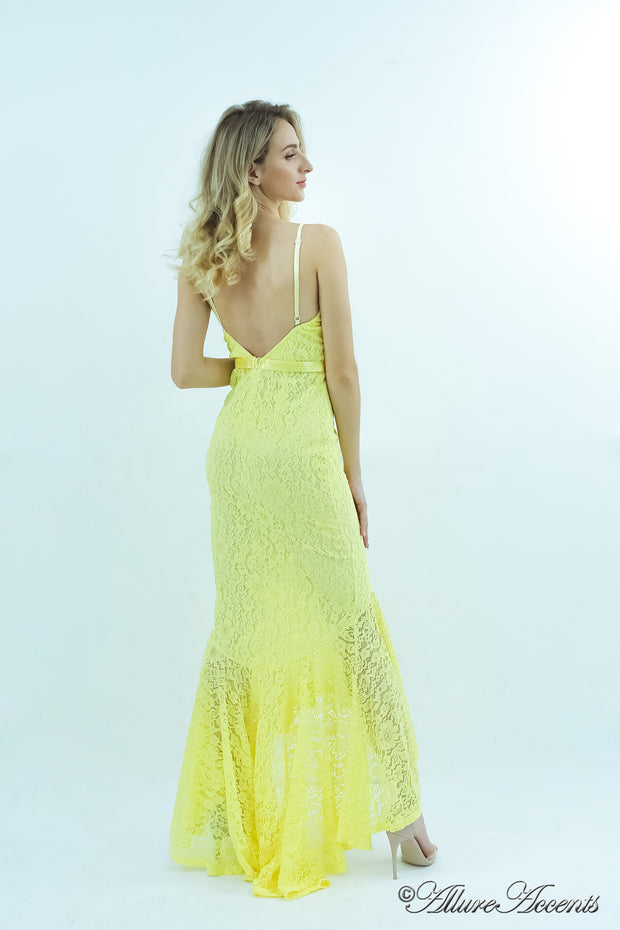 Woman showing a yellow high-low floral lace dress has a low back opening.