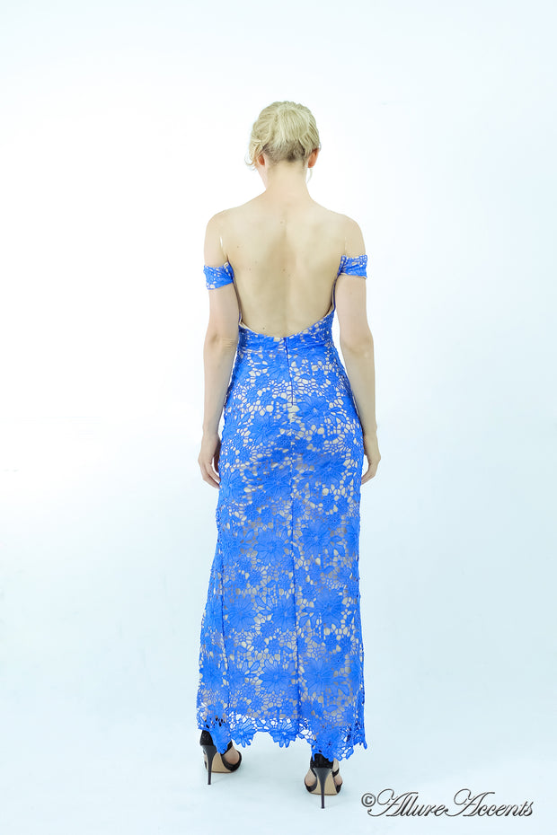 Woman showing her off-the-shoulder blue lace dress has a low cut back. 