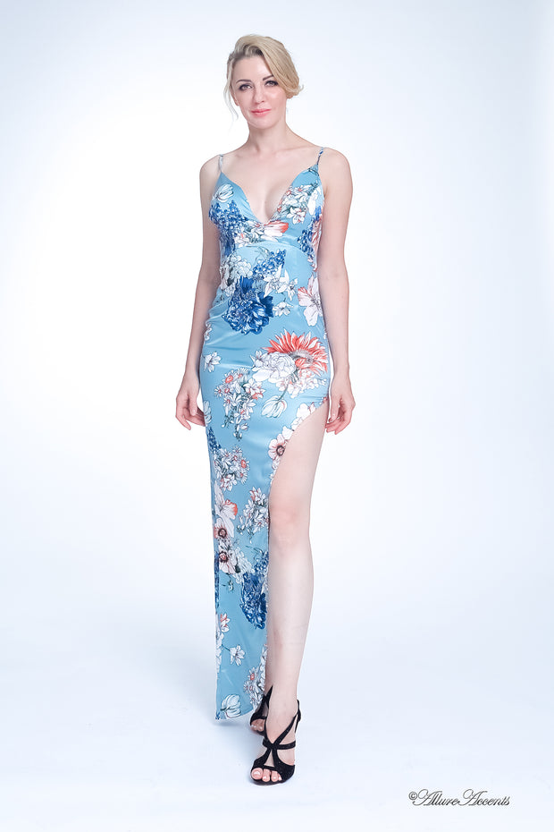 Woman wearing a blue summer floral party maxi, low cut back and has sexy side slit 