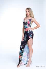Woman wearing a black summer satin floral party maxi, low cut back and has sexy side slit 