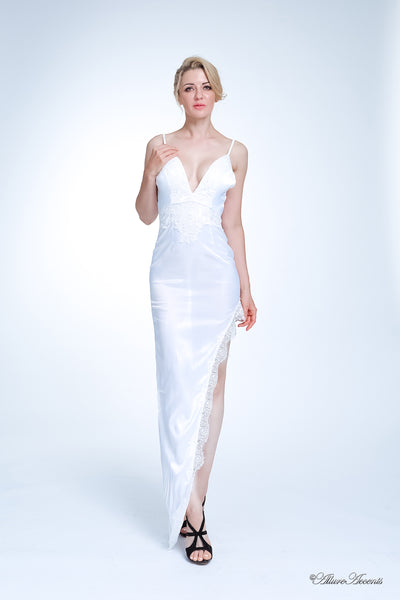 woman wearing a sexy long high slit white satin dress with lace details 