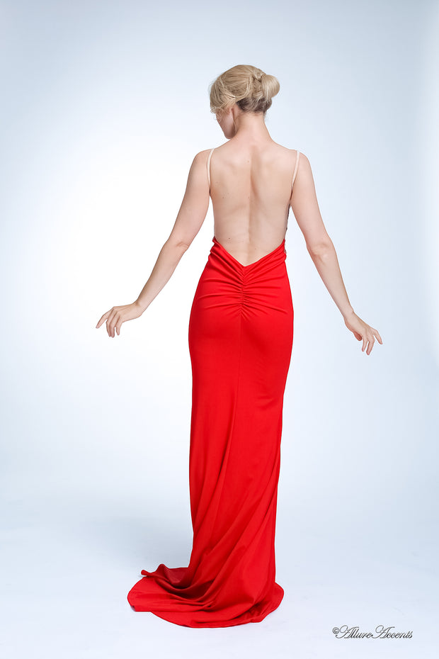 Woman showing her long red gown is backless and has ruching on the butt. 