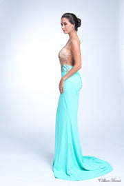 Woman wearing a sequined long tiffany blue colored gown.
