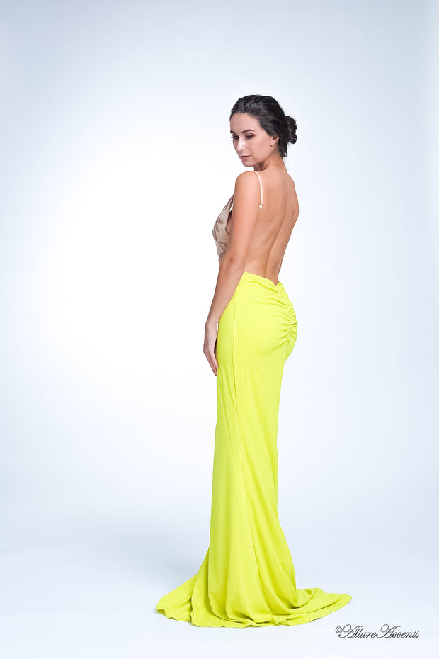 Woman showing her lemon yellow colored gown is backless.