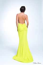 Woman wearing a long lemon yellow colored sequined gown.