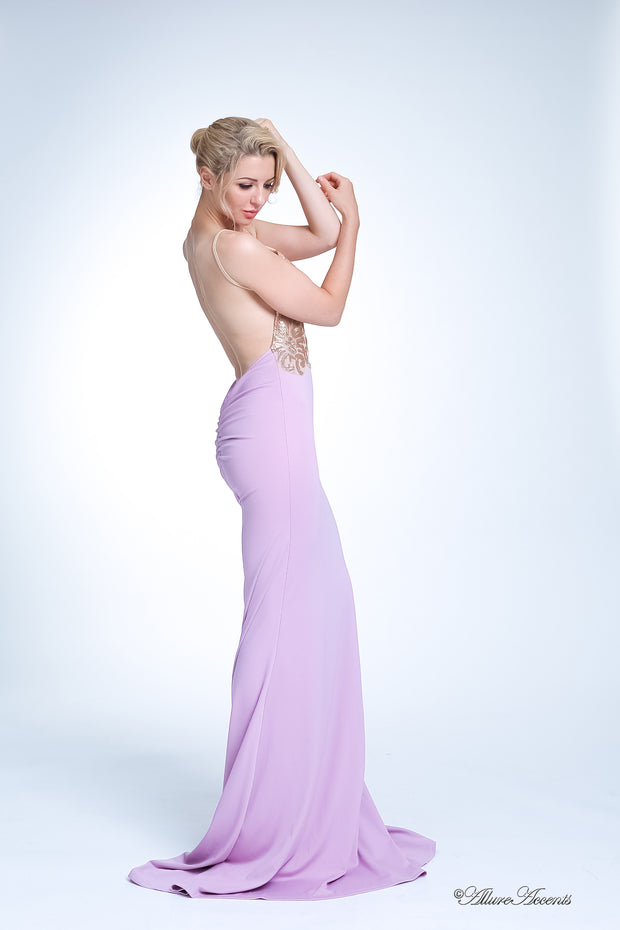 Woman wearing a long lavender colored sequined gown.