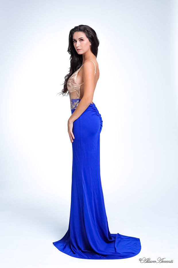 Woman wearing a long royal blue colored sequined gown.